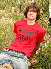 Naked long-haired boy posing outdoor